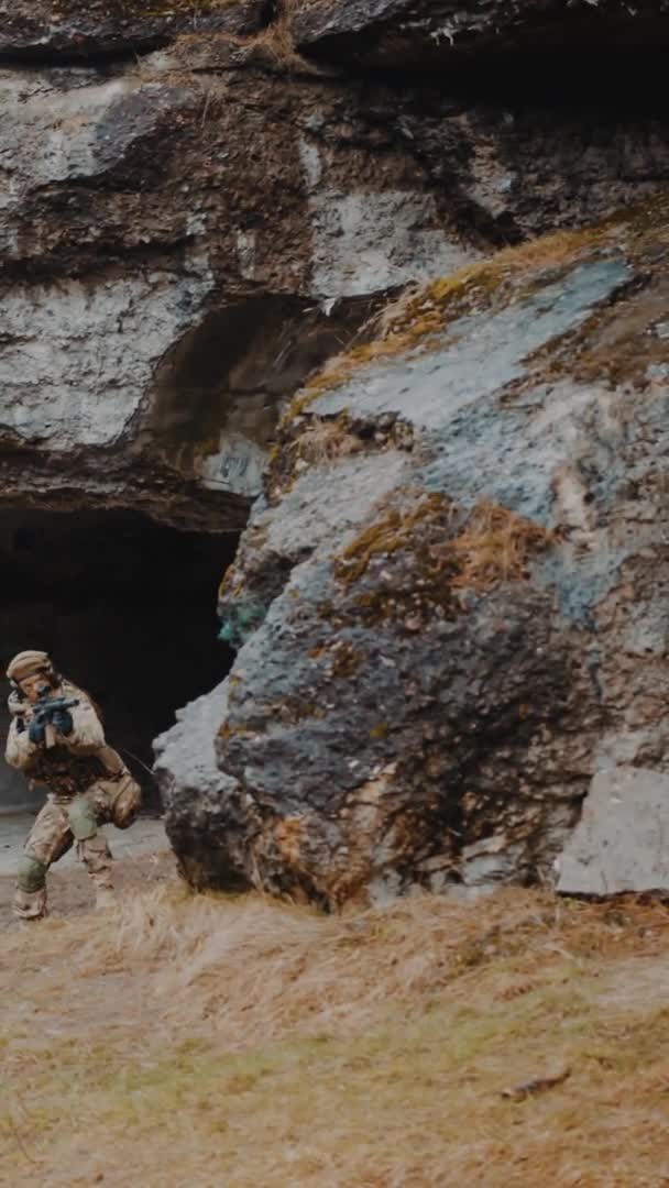 Vertical Shot - Vigilant soldiers entering cave territory of rebels — Stock Video