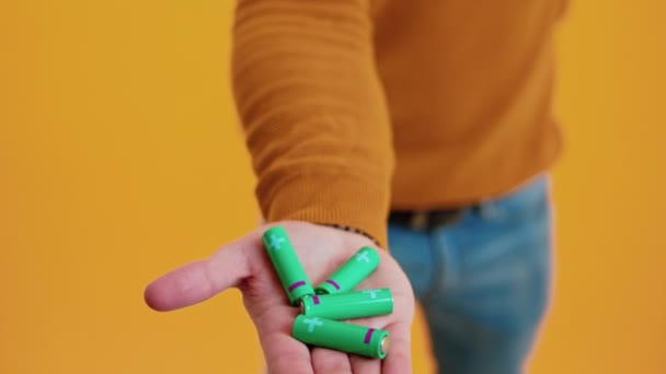 Palm of a caucasian person holding green batteries. Ecology and recycling concept. — Vídeo de Stock