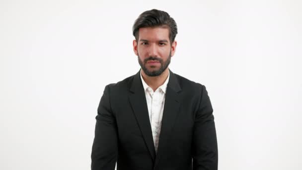 Handsome stylish Hispanic boss showing silence finger gesture - isolated portrait shot on white studio background — Vídeos de Stock