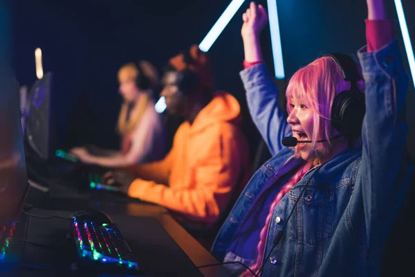 Girl with pink hair winning online video game cyber sport concept neon colors medium closeup indoors —  Fotos de Stock