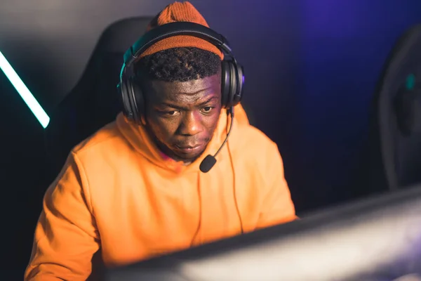 Professional Afro American man playing and streaming online video game battle cyber sport medium closeup indoors — Fotografia de Stock