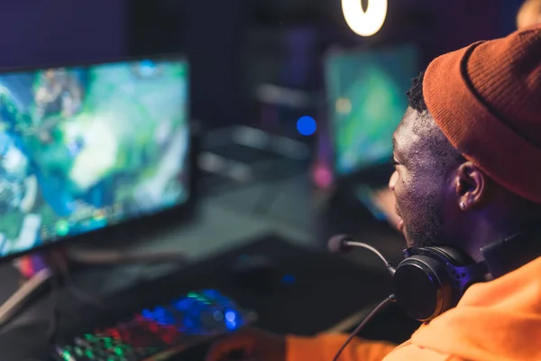Afro American young man playing online video games game battles esport concept closeup neon light indoors —  Fotos de Stock