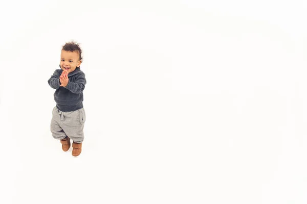 Handsome toddler standing on the floor applauding and smiling — Photo