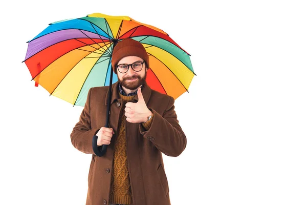 Hombre barbudo dando pulgares hacia arriba gesto de la mano al tiempo de lluvia. Hipster sosteniendo paraguas colorido. Hombre de la lluvia. El colorido paraguas nunca deja de llamar la atención. —  Fotos de Stock