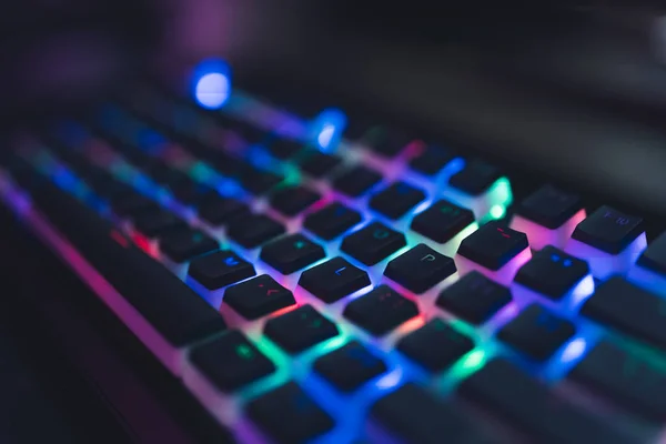 Colourful illuminated gamer keyboard with black push-bottoms. Red, green, blue, pink. —  Fotos de Stock