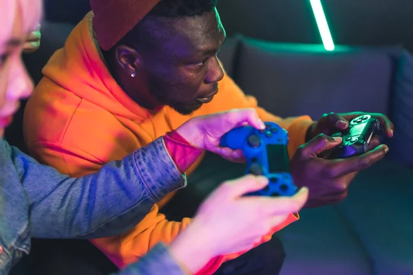 Young Asian woman and Afro-American man playing video games closeup selective focus copy space — Stockfoto