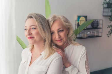 family generation concept, mom and daughter looking at the window together