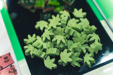 Kenevir çikolatası hoş yeşil bir renkte kenevir yaprakları şeklinde. Yüksek kalite fotoğraf