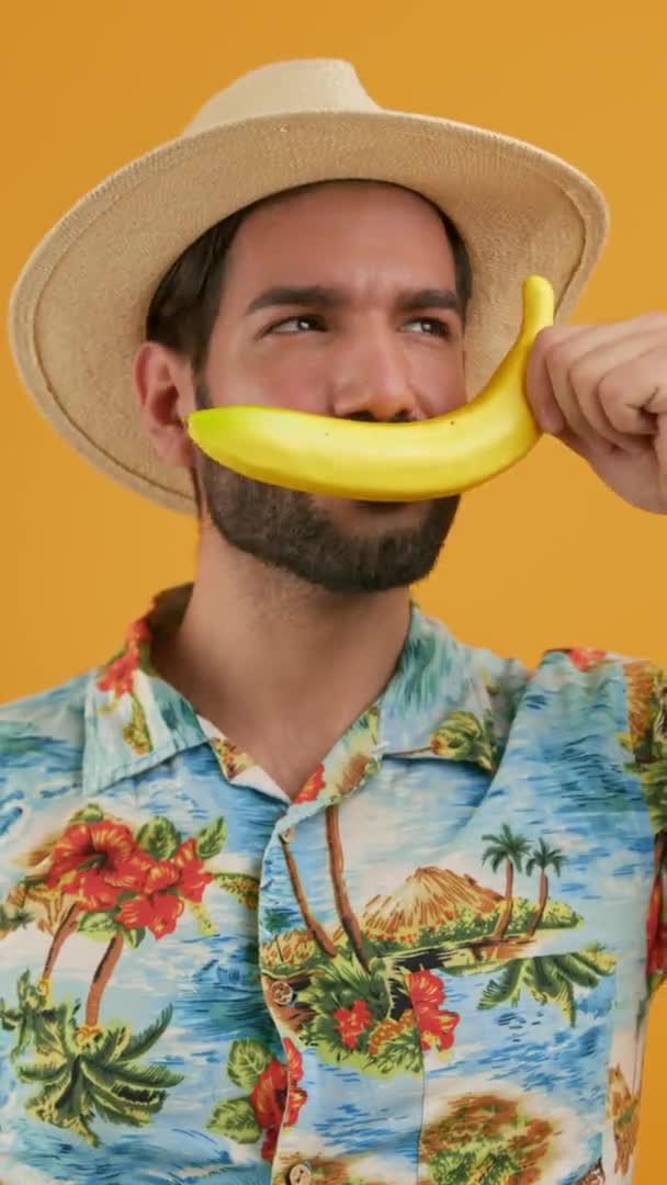 Latin Bearded Man Beachwear Talking Banana Yellow Background Studio Isolated — Stock Video