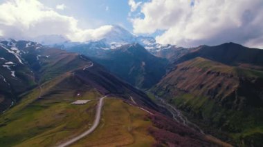 Gürcistan, Kazbegi 'deki Kafkasya Dağları' ndaki dolambaçlı bir yolun yükselen manzarası. Yüksek kalite 4k görüntü