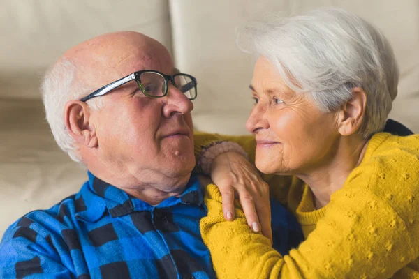 portrait of a happy Caucasian grandparents looking at each other with endless love at home medium closeup senior people love concept. High quality photo