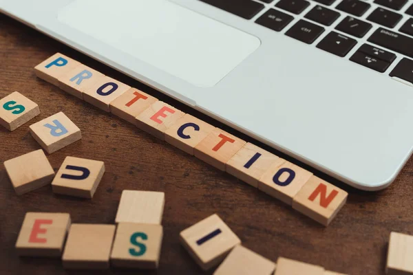 Protection. Graphic photo idea for companies who would like to present important concept via unconventional ways. Word letters on puzzles made from wood. High quality photo