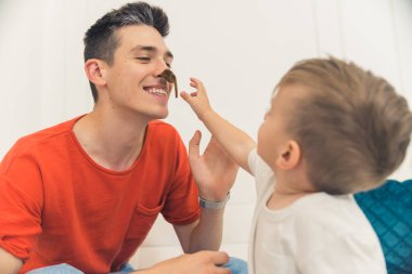 little boy spending time with his young and handsome father. High quality photo