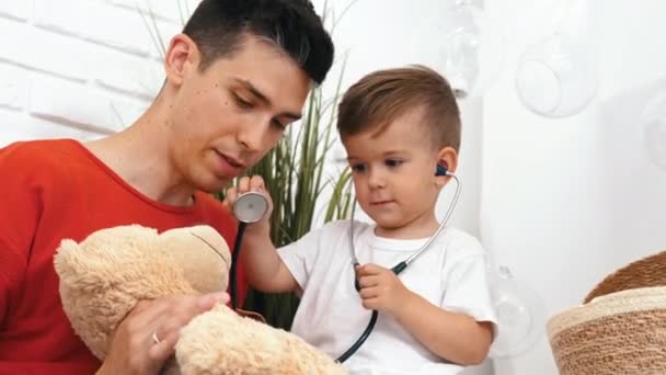 Little Caucasian Boy Listening Heartbeat His Teddy Bear His Dad — Stock Video
