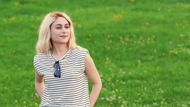 Blond Caucasian Girl Smiling Park Green Grass Medium Shot Copy — Wideo stockowe