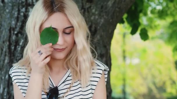 Blond Caucasian Girl Holding Small Green Leaf Close Eye Medium — Vídeo de stock