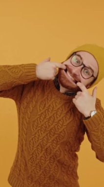 Funny young Caucasian man in his 30s smiling and widening his mouth with his fingers to show his teeth- silly face - dental care Vertical. High quality 4k footage