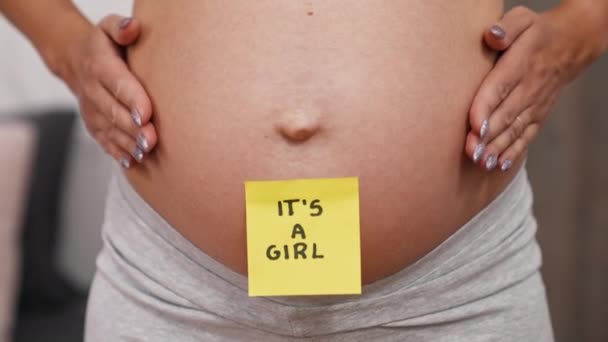 Pregnant Woman Sticky Note Saying Girl Her Belly Closeup Gender — Video