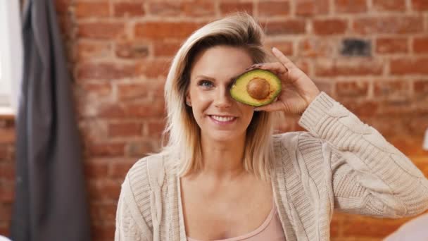 Excited Blond Caucasian Woman Ripe Delicious Avocado Home Medium Closeup — Vídeos de Stock