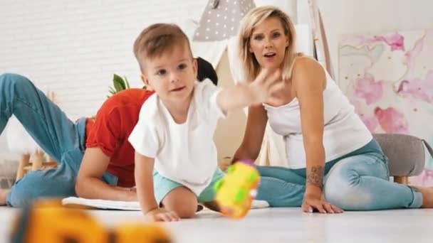 Cute Heterosexual Married Couple Sitting Floor Playing Preschooler Son Boy — Αρχείο Βίντεο