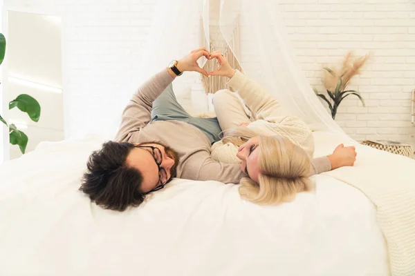 A love couple lying on bed enjoying each other -white background . High quality photo