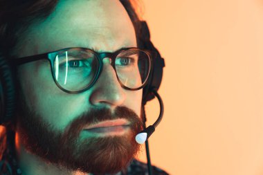 Close up of the professional bearded crypto currency analytic watching closely to the statistics. High quality photo