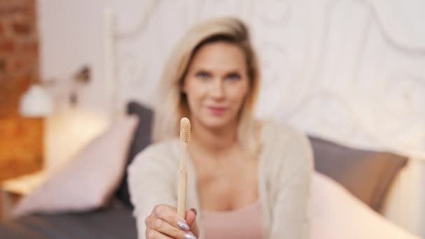 Indoor Portrait Eco Bamboo Toothbrush Held Blurred Unrecognizable Blond Caucasian — Stockvideo
