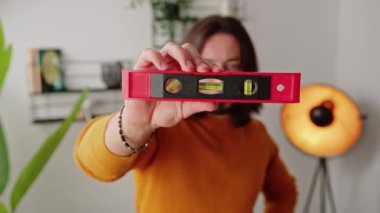 A long haired man in his 30s keeping a long red thing in his hands. High quality 4k footage