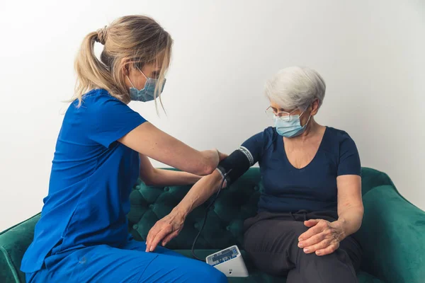Caucasian Nurse Wearing Dark Blue Uniform Face Mask Sitting Her — стокове фото