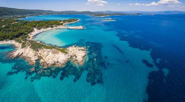 Drone aerial view of a beautiful turquoise-dark blue waters of Karydi Beach. Summer destination concept. High quality photo