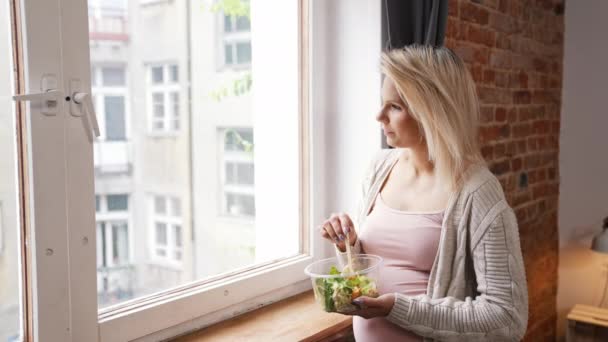Young Pregnant Woman Holding Salad Looking Out Window Medium Shot — Vídeos de Stock