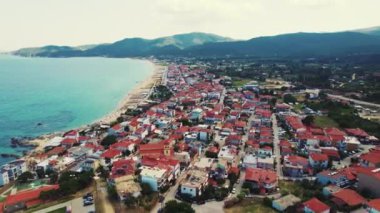 Sarti, Greece. Shallow turquoise seawater, long beach, and whitewashed houses with orange roofs as essential Greek scenery. High quality 4k footage