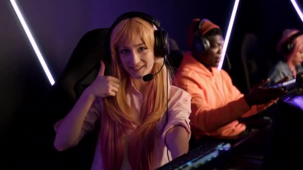 Teenage Gamer Girl Wearing Headset Holding Colorful Keyboard Giving Thumbs — Stockvideo