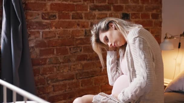 Tired Pregnant Caucasian Woman Sitting Bed Touching Her Belly Thinking — Vídeos de Stock