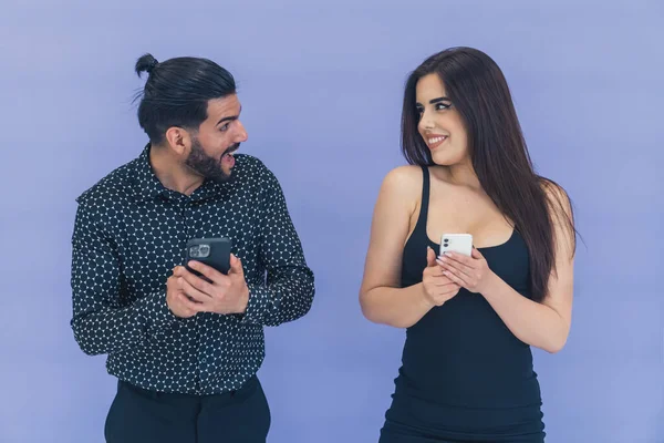 Excited Young Happy Couple Standing Next Each Other Texting Smartphones — Fotografia de Stock