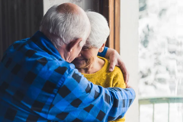 Happy Loving Senior Husband Wife Smiling Hugging Window Living Room — ストック写真