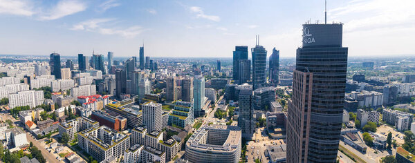 7.22.2022 Warsaw, Poland. Wide panoramic aerial shot of downtown Warsaw cityscape and Warsaw Trade Tower in the foreground. Beautiful sunny weather. High quality photo