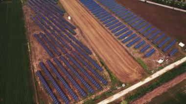 beautiful aerial view of solar panel cell on the field and Mt Osa in background, Greece. High quality 4k footage