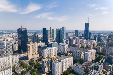 7.22.2022 Warsaw, Poland. Corporations building skyscrapers in the downtown Warsaw. City skyline during summertime. High quality photo