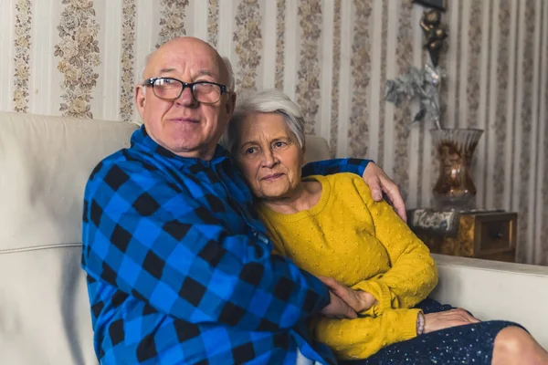Relaxed Married Elderly Man Woman Hugging While Sitting Couch Looking — Stockfoto