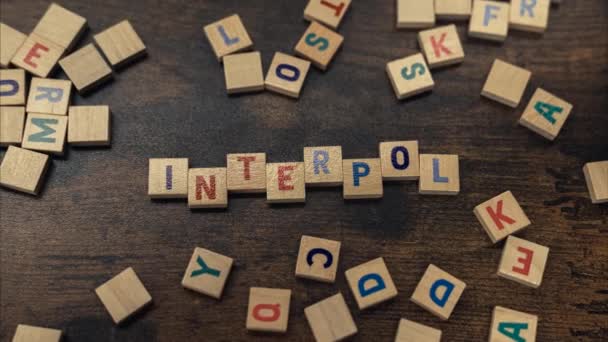 Top View Colorful Square Wooden Letters Creating Word Interpol International — Stok video