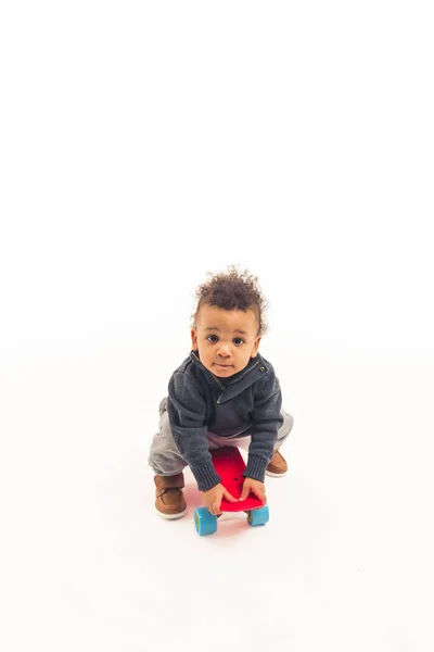 Little Five Years Old Afro American Guy Sitting Skateboard Looking – stockfoto