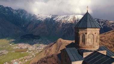 great Gergeti Trinity Church and breathtaking Caucasus mountains in the background, Georgia. High quality photo