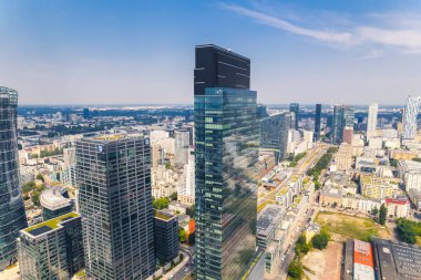 7.22.2022 Warsaw, Poland. Neomodern, high, and beautiful Warsaw Unit skyscraper in Daszynski Roundabout in Wola district. Aerial drone perspective. High quality photo