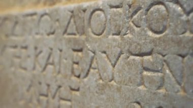 Ancient Greek manuscript engraved in a stone wall. Inscription written in ancient Greek. High quality 4k footage