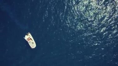 One lonely white sailboat in a vast rippled Aegean Sea. Greece. Aerial drone view. High quality 4k footage