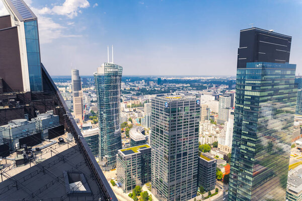 7.22.2022 Warsaw, Poland. Unusual perspective over Warsaw Unit skyscraper as if from the rooftop of Skyliner. Warsaw Spire in the background. High quality photo