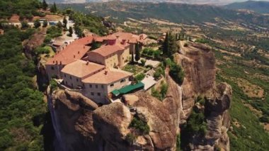 High above the Meteora landscape in central Greece, Thessaly. The holy Grand Meteoron Monastery, near the town of Kalabaka. Panoramic aerial view of rock formations and incredible nature. High quality