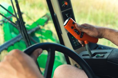 closeup view of farmers hands driving combine harvester, tractor operating controlling machinery. High quality photo