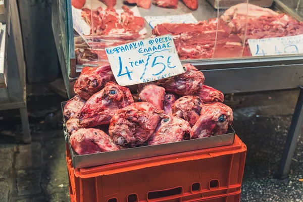 Butchers area in Kapani Market in Thessaloniki, Greece. Container full of sheep heads for sale. Unconventional cuisine concept. High quality photo